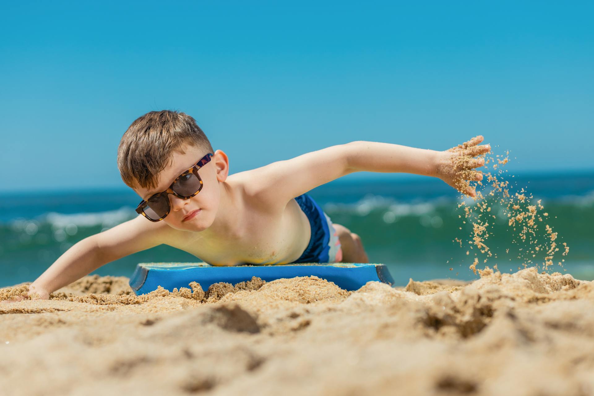 A kid practicing surfing